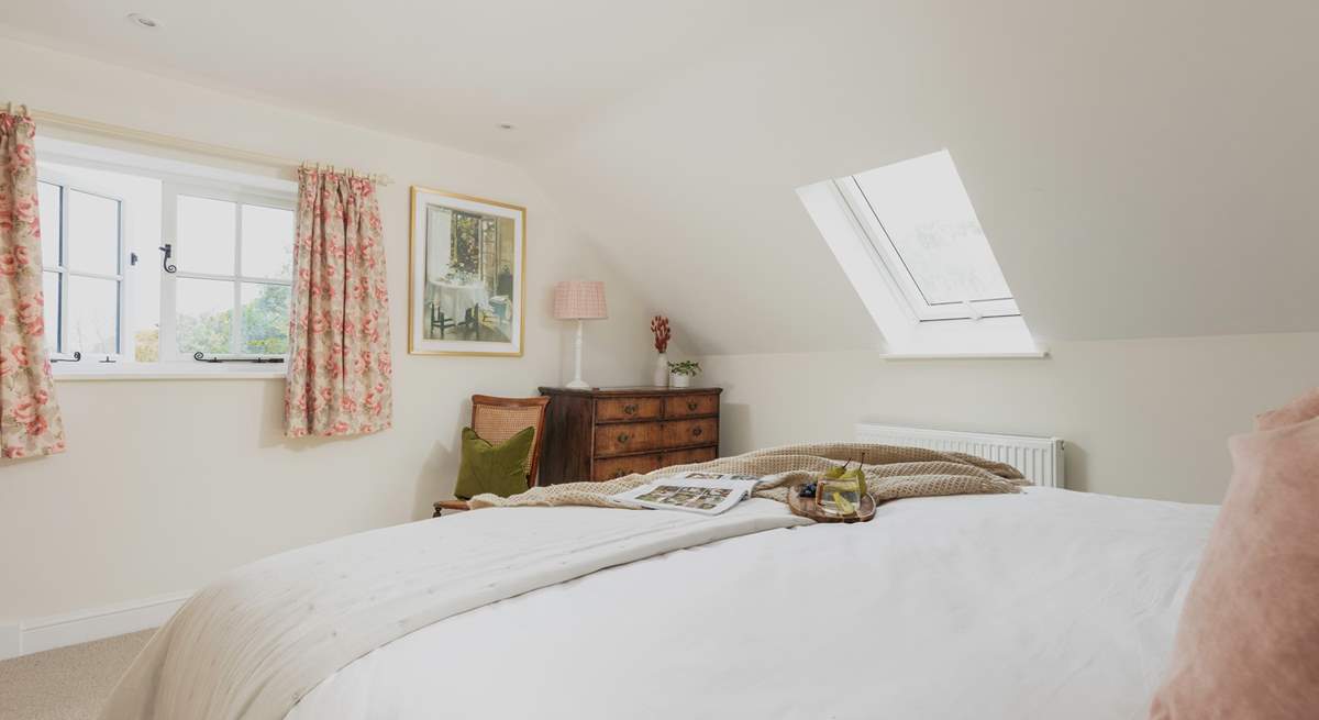 This double aspect bedroom has lovely rural views out across the garden.