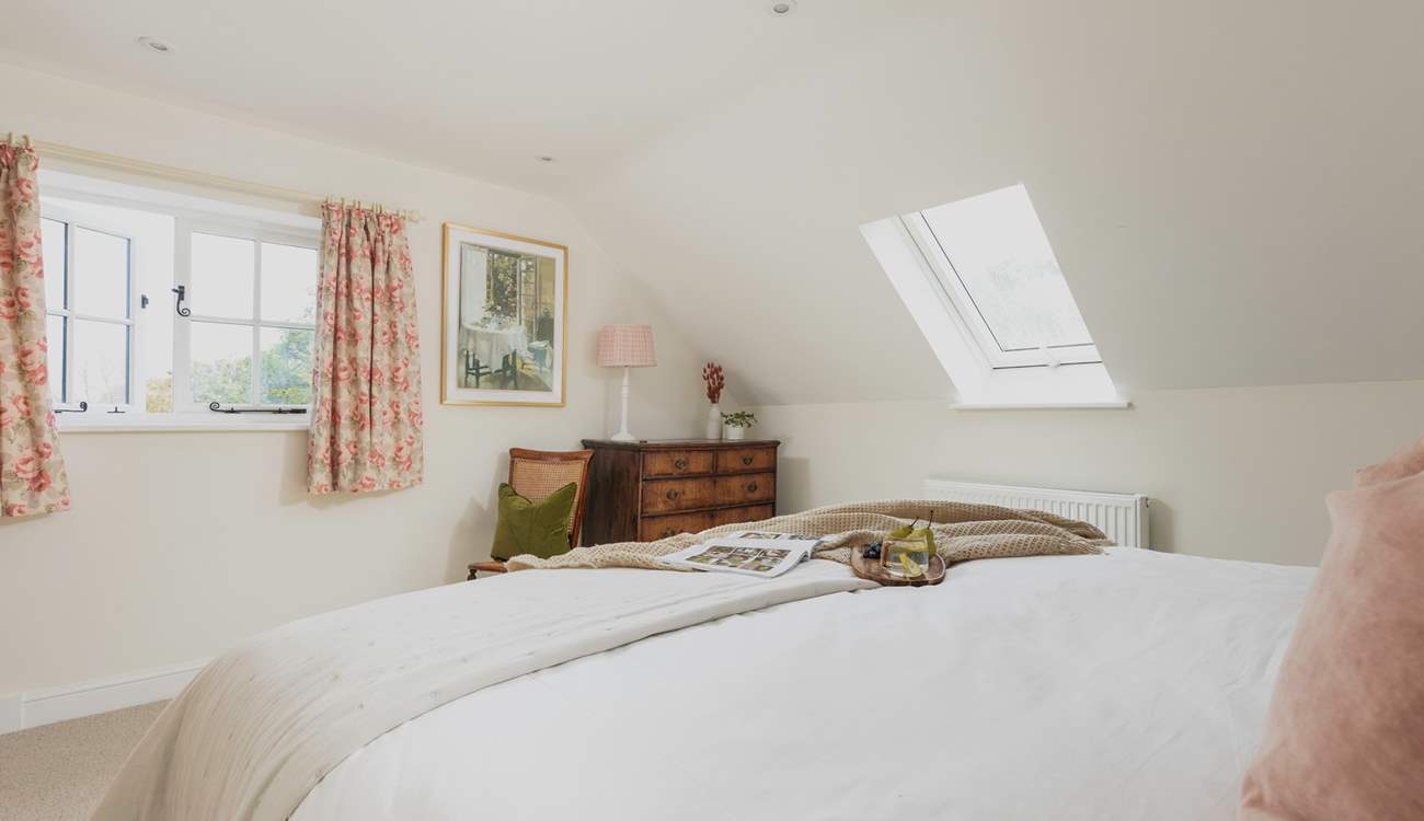 This double aspect bedroom has lovely rural views out across the garden.