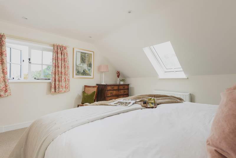 This double aspect bedroom has lovely rural views out across the garden.