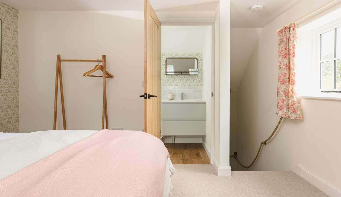 Head through to the en suite bathroom or downstairs.