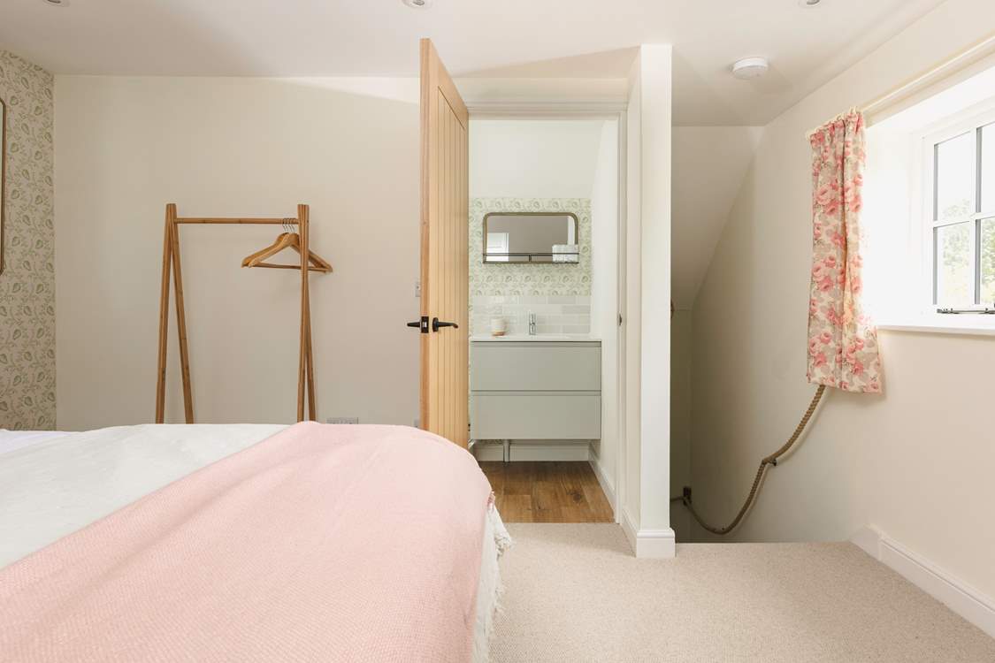Head through to the en suite bathroom or downstairs.