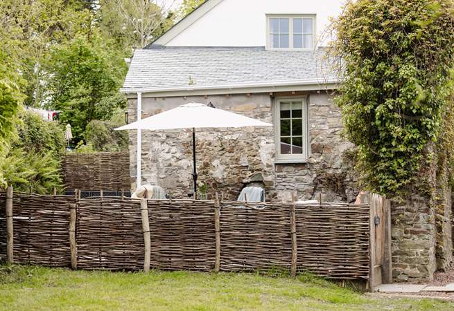 The garden is fully enclosed with a table and chairs - not forgetting the swing chair!