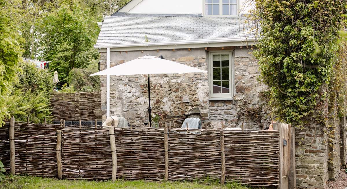 The garden is fully enclosed with a table and chairs - not forgetting the swing chair!