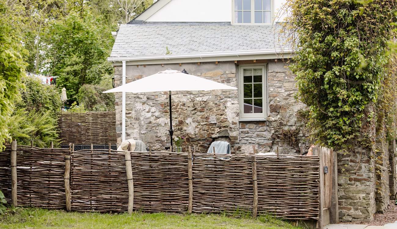 The garden is fully enclosed with a table and chairs - not forgetting the swing chair!