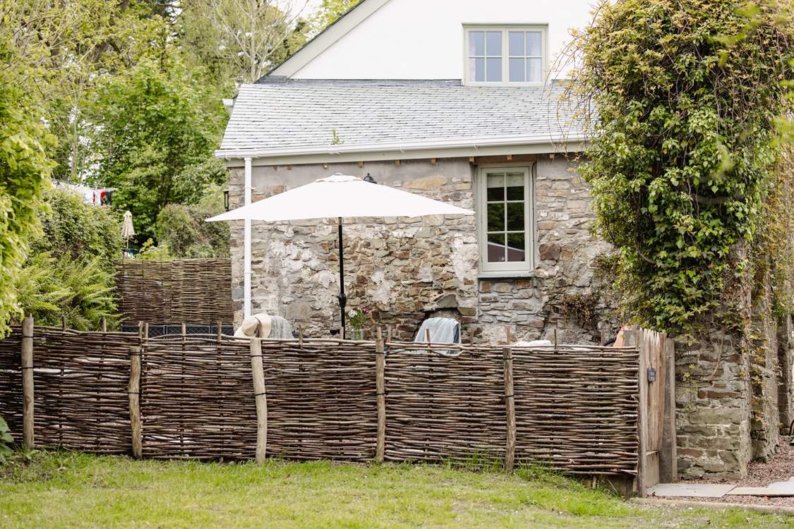 The garden is fully enclosed with a table and chairs - not forgetting the swing chair!