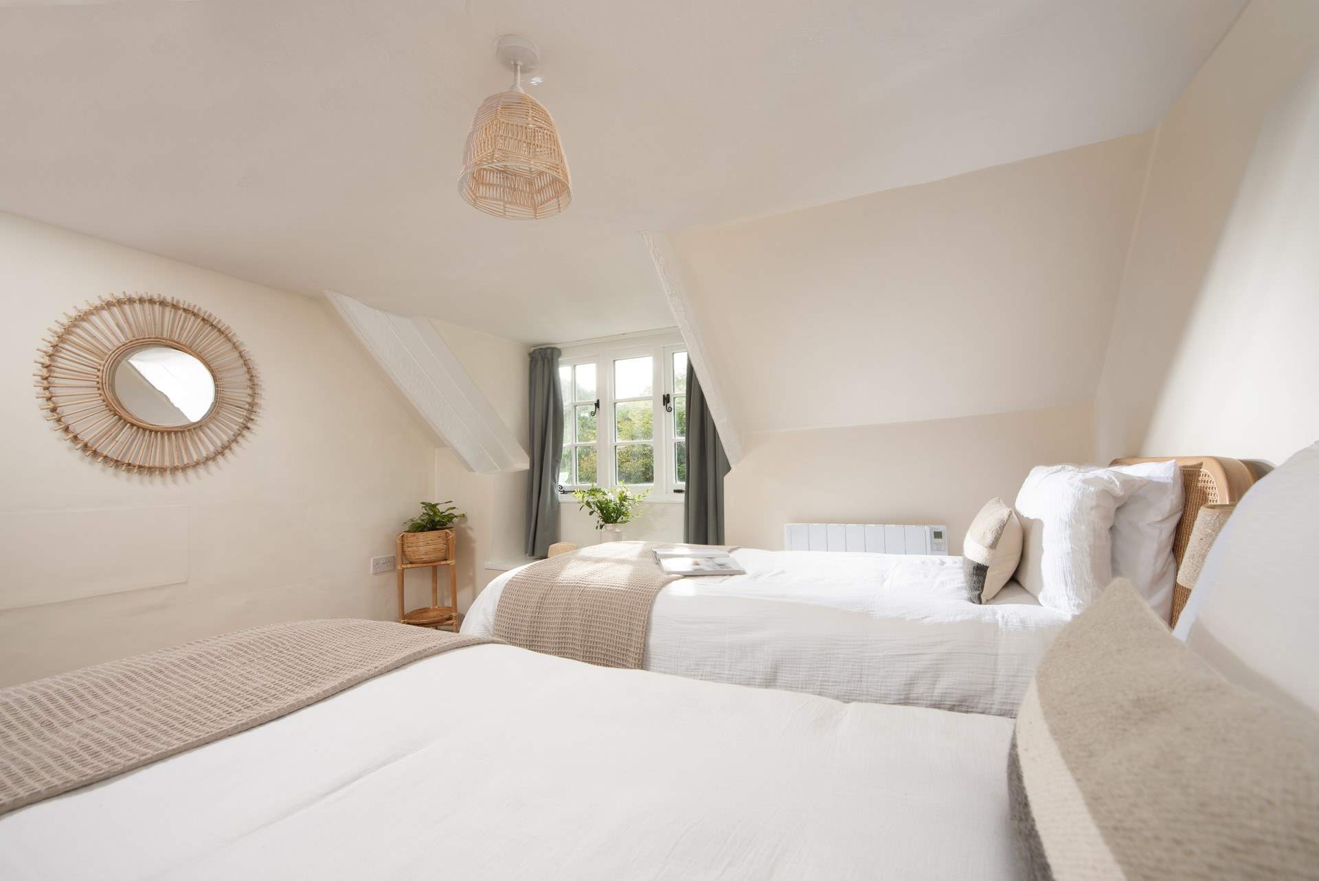 Set under the eaves on the second floor, the sloping ceiling and exposed beams add to the charm of the room.