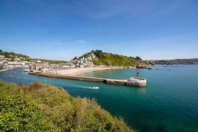 Grab some fish and chips in the town of Looe, best enjoyed sitting on the Banjo Pier that juts out into the sparkling sea.