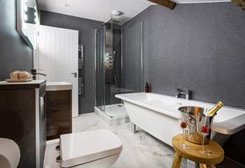 Rain head shower and free-standing bath in the en suite of bedroom 3.