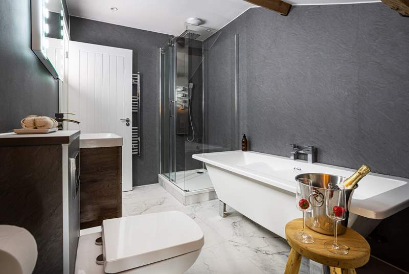 Rain head shower and free-standing bath in the en suite of bedroom 3.