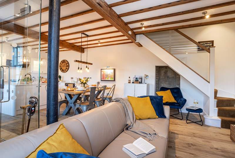 The open plan living is perfect for get togethers, look at the amazing beams and original column, a nod to the history of Beckstones House. 