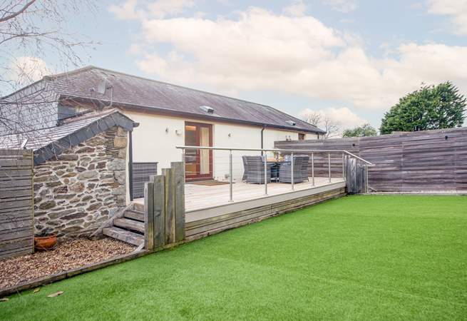 A large and safe space in the secure, enclosed garden, with no worries about muddy paws on the Astroturf.