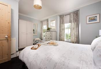 The large principle bedroom decorated in calming tones.  