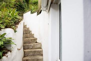 Steps (20 in total if you count from the bottom right up to the very top) lead up to the decked terrace.