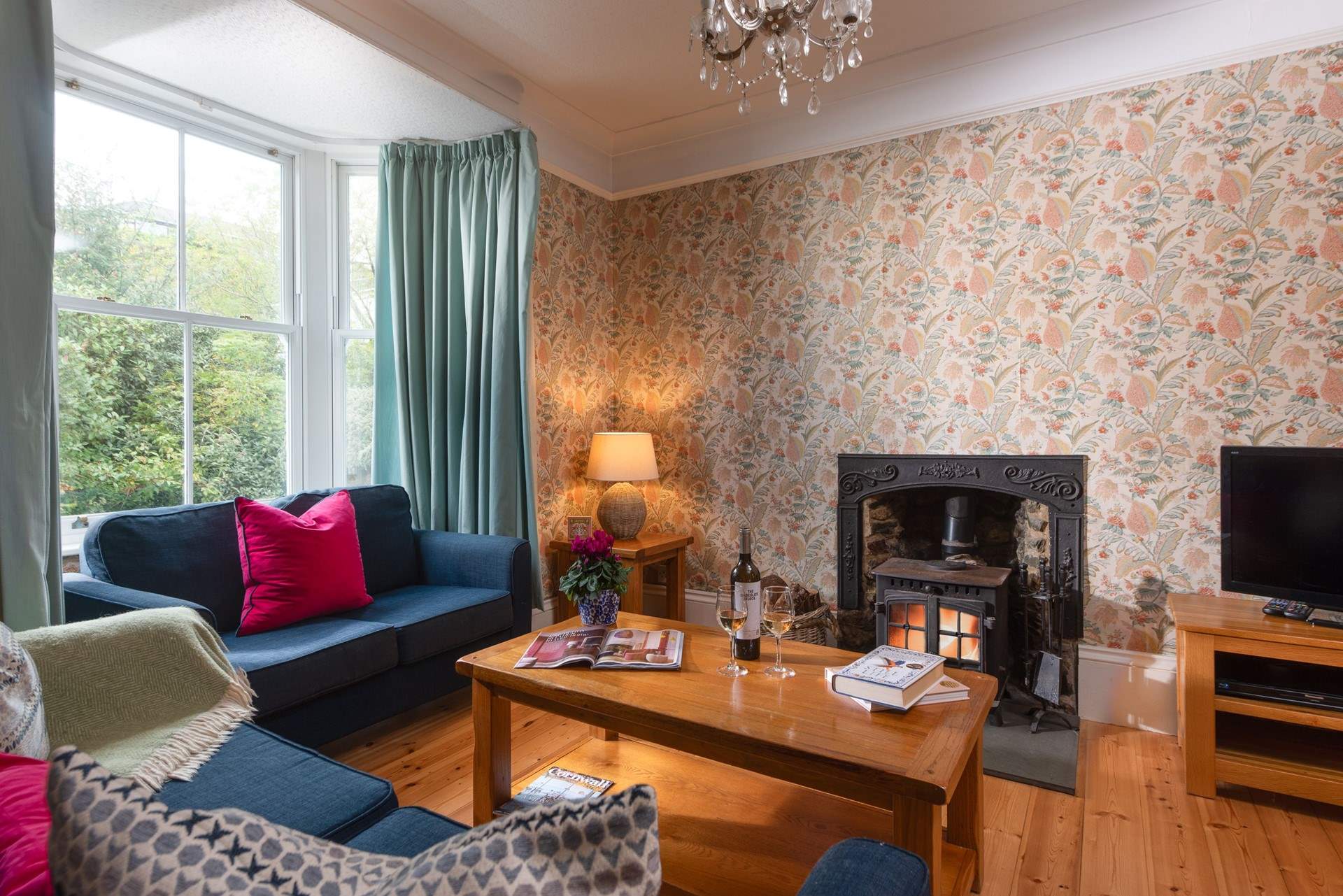 There is plenty of space for everyone to relax around the fire with a good film.