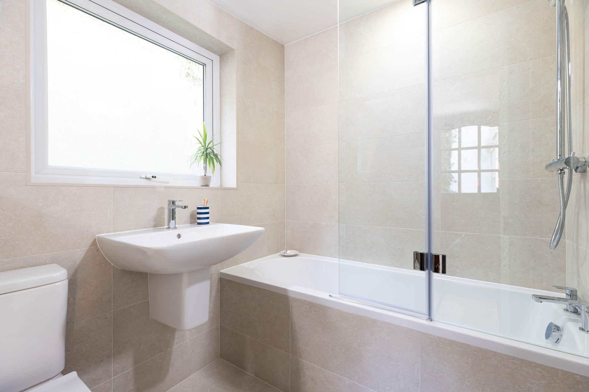The family bathroom on the ground floor with a bath for long soaks. 