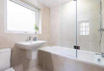 The family bathroom on the ground floor with a bath for long soaks. 