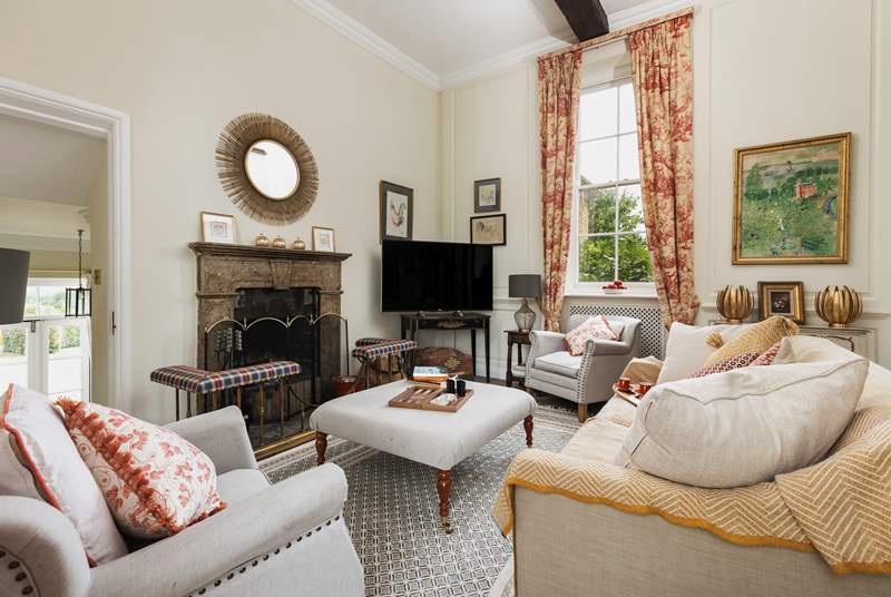 The delightfully cosy sitting-room is the perfect place to snuggle up with your family after a day exploring the Cotswold countryside.