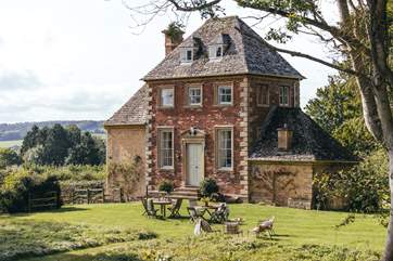 The original red brick side of The Summer House was built in 1720 as a banqueting house at the head of the carp ponds.