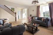 The sitting-room leads onto the front garden, look at the sun streaming in.