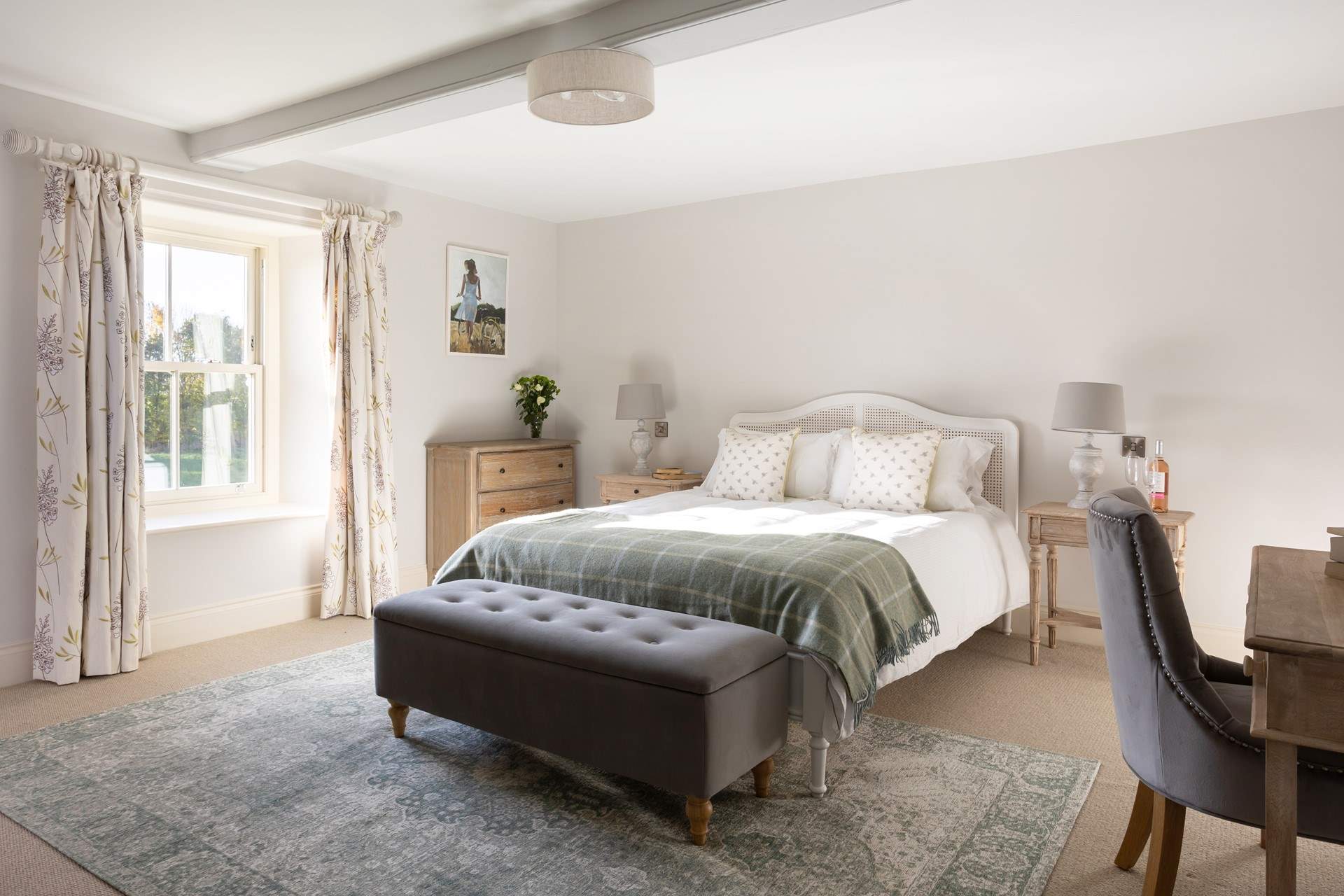 A light and airy bedroom with a lovely king-sized French inspired bed.