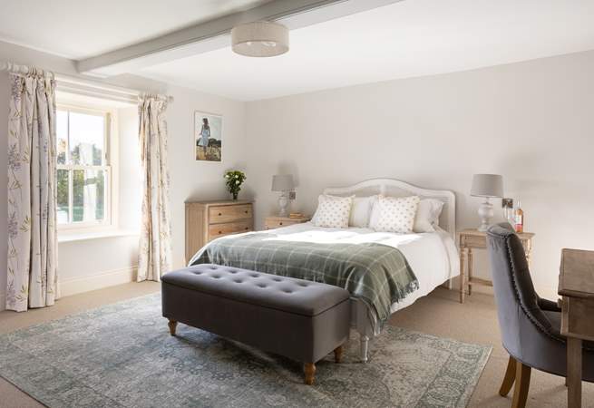 A light and airy bedroom with a lovely king-sized French inspired bed.