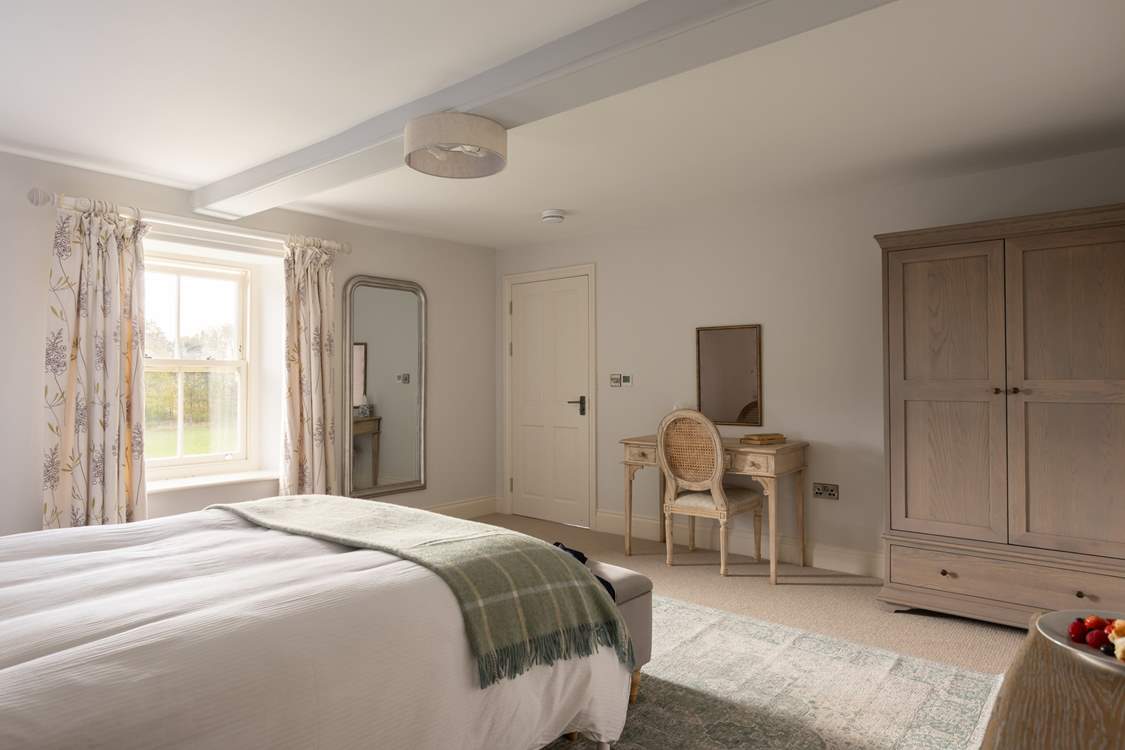 This king-size bed has fabulous linens to snuggle under.
