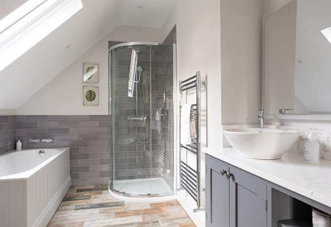 En suite bathroom, enjoy a long soak after a busy day.