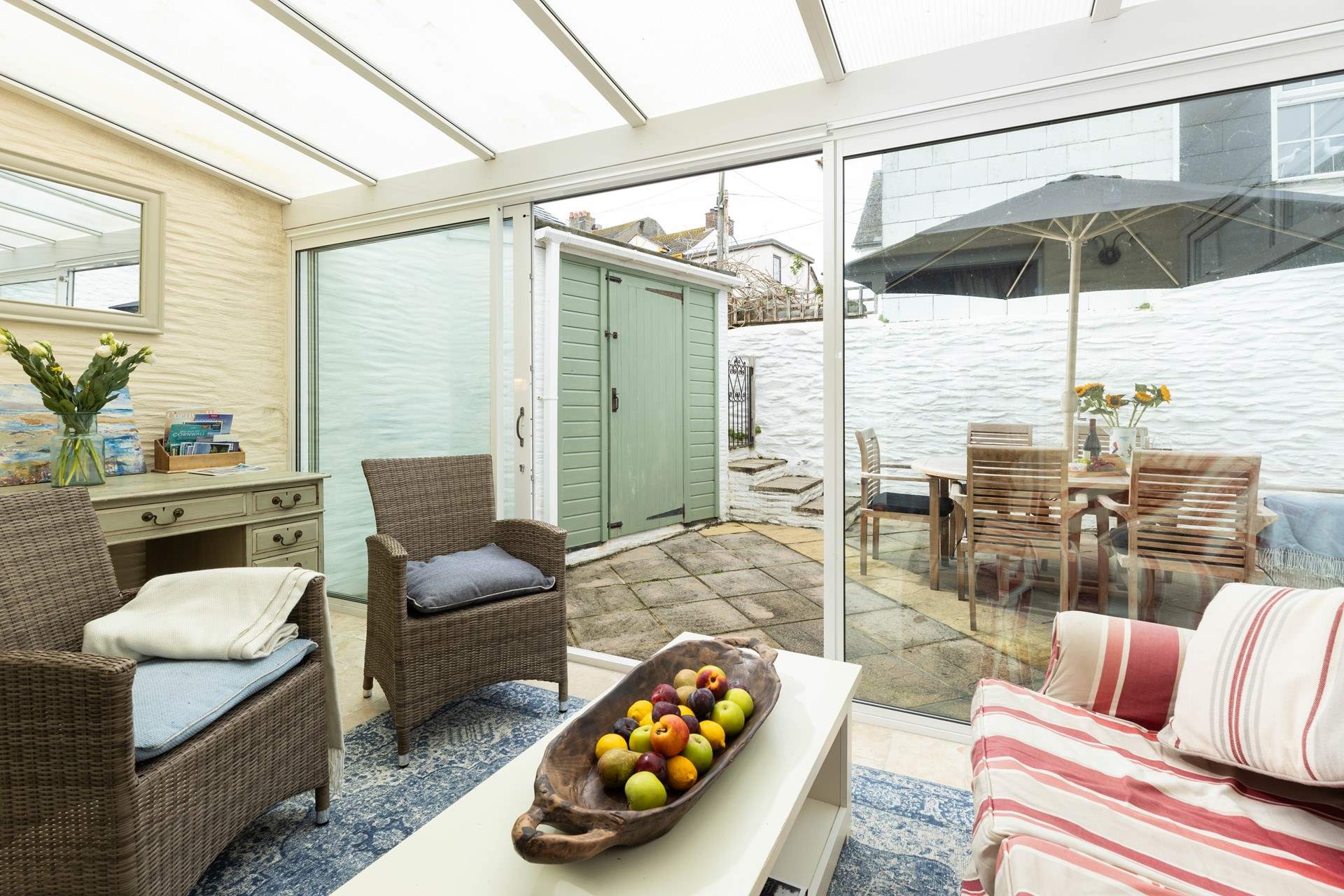 The sun-room offers additional seating and leads out to the patio.