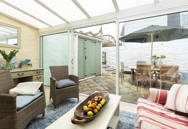 The sun-room offers additional seating and leads out to the patio.