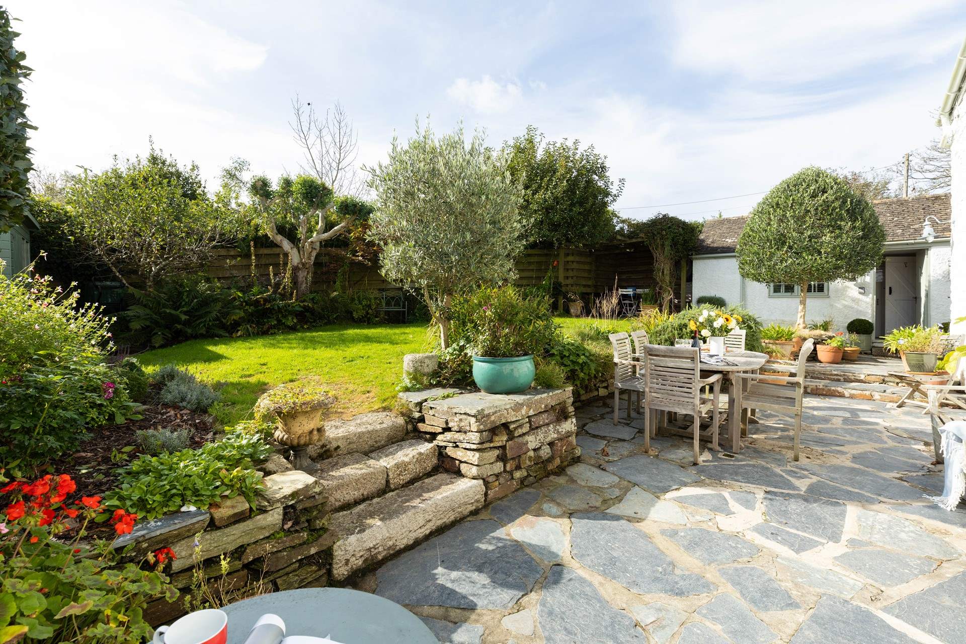 Beautiful garden with plenty of flora, the annexe is located to the right-hand side.