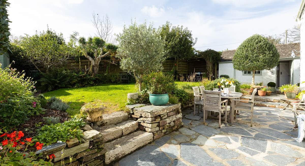 Beautiful garden with plenty of flora, the annexe is located to the right-hand side.