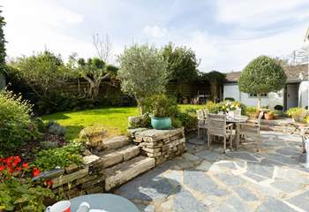 Beautiful garden with plenty of flora, the annexe is located to the right-hand side.