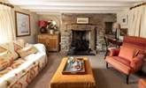 The cosy sitting-room has a wood-burner for cooler months.  - Thumbnail Image