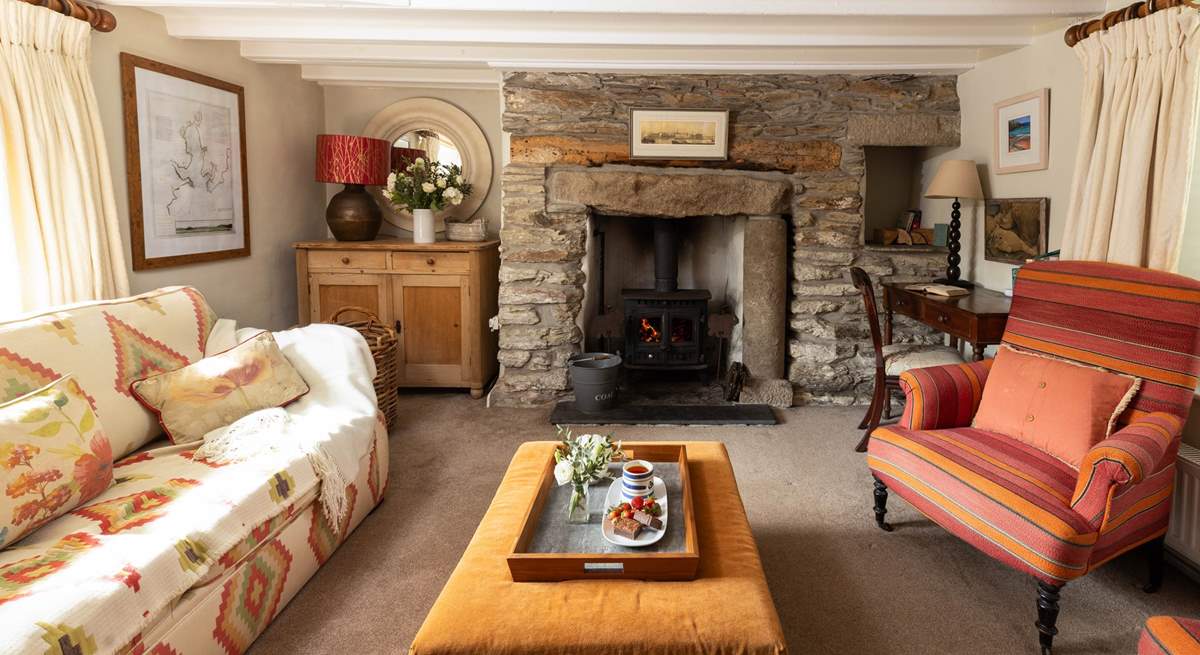 The cosy sitting-room has a wood-burner for cooler months. 