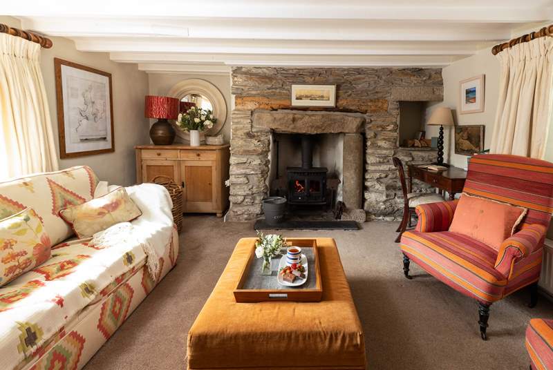The cosy sitting-room has a wood-burner for cooler months. 