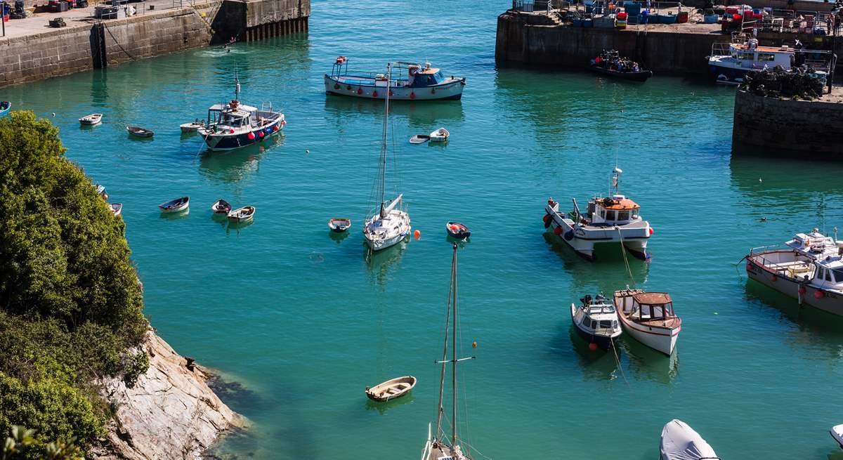 Boats bob on the water in Newquay harbour.