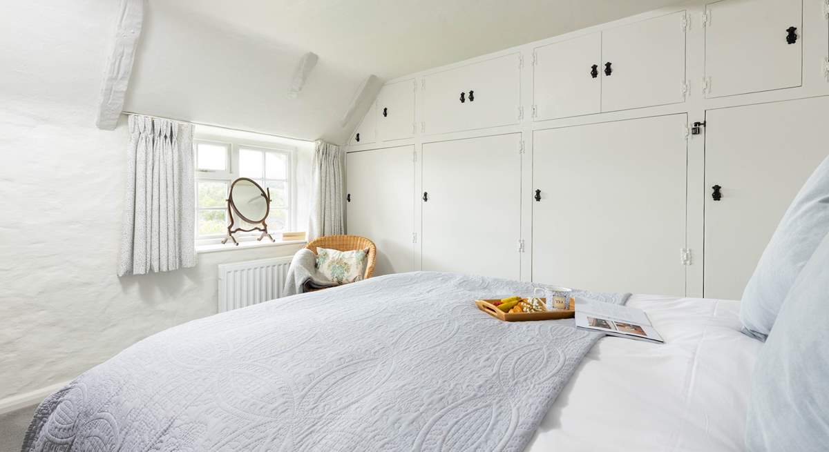 Bedroom 1 overlooks the garden and valley beyond. 