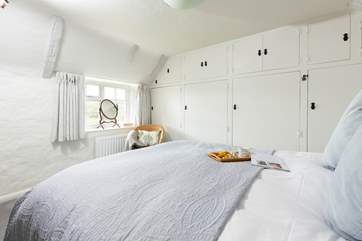 Bedroom 1 overlooks the garden and valley beyond.