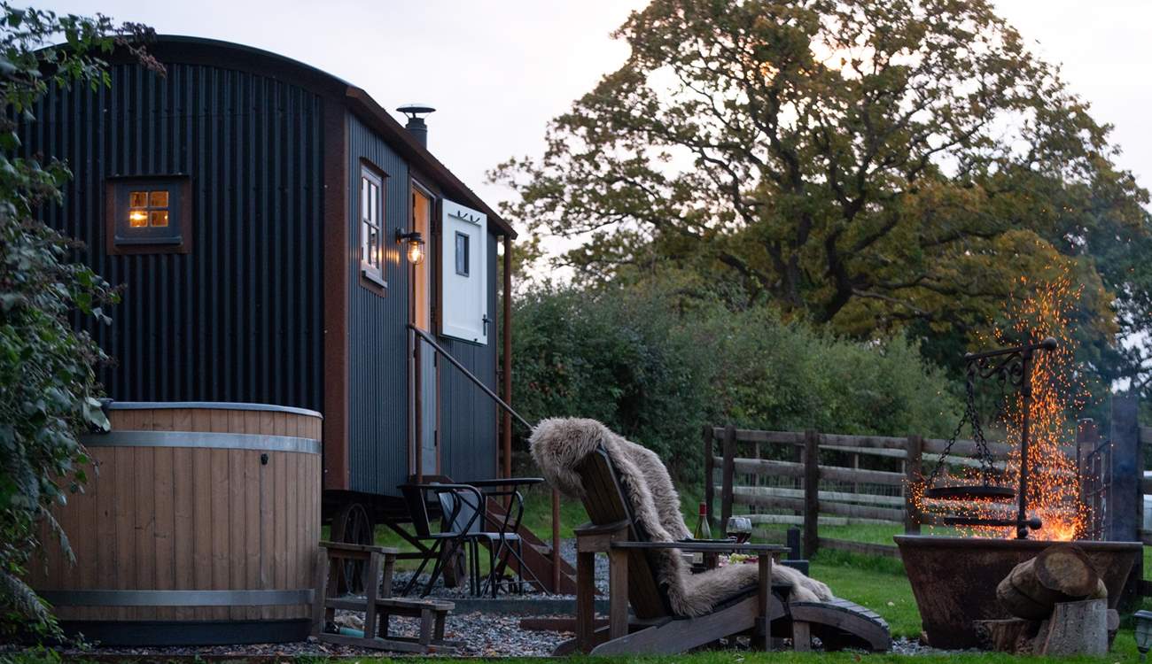 Magical moments await - soak in the steamy hot tub or stay snug beside the flickering fire-pit. 