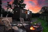 Magical moments await - soak in the steamy hot tub or stay snug beside the flickering fire-pit. 