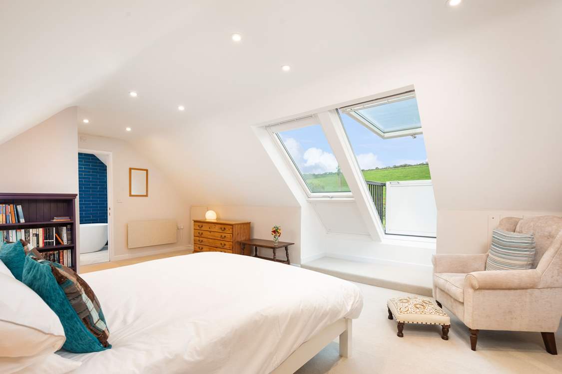On the first floor, the spacious luxurious en suite with Velux roof balcony is a joy.