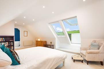 On the first floor, the spacious luxurious en suite with Velux roof balcony is a joy.