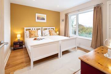 Soothing and stylish, the twin room on the ground floor, which enjoys panoramic views towards the mountains.