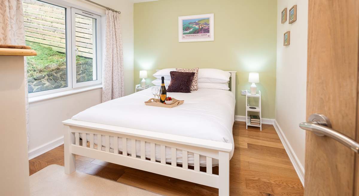 Situated next to the ground floor twin room is one of two double rooms, with king-size bed and garden views. 