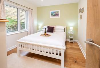 Situated next to the ground floor twin room is one of two double rooms, with king-size bed and garden views. 