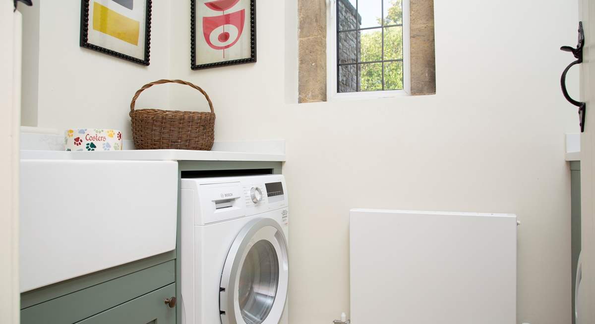 The utility-room with washing machine/drier.