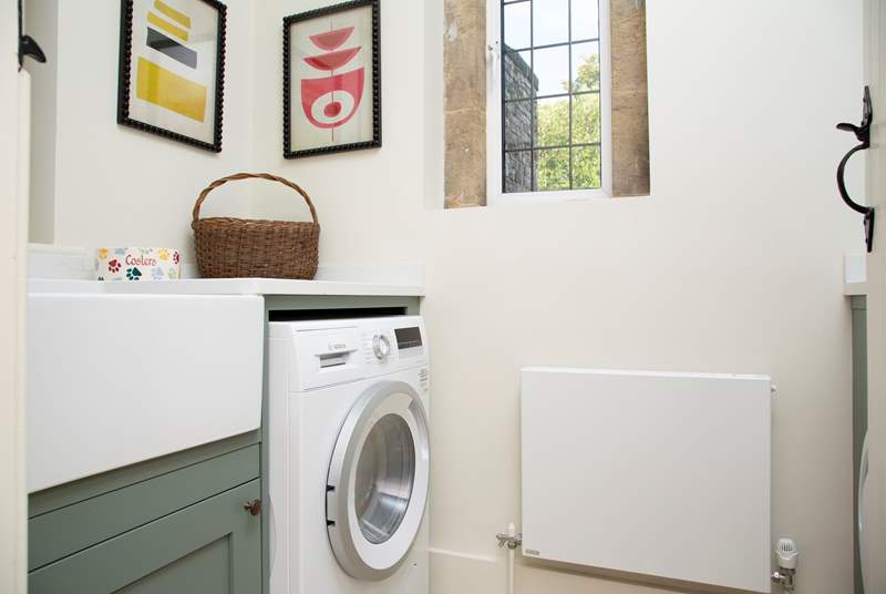 The utility-room with washing machine/drier.