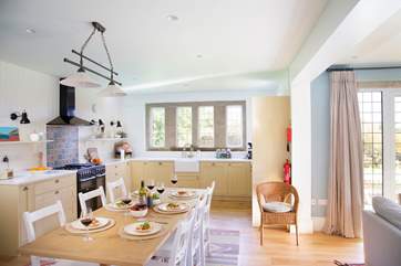 The kitchen is fully equipped and a sociable space to cook whilst chatting to family and friends.