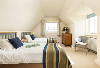 Bedroom 3 has twin beds and cosy linens. 