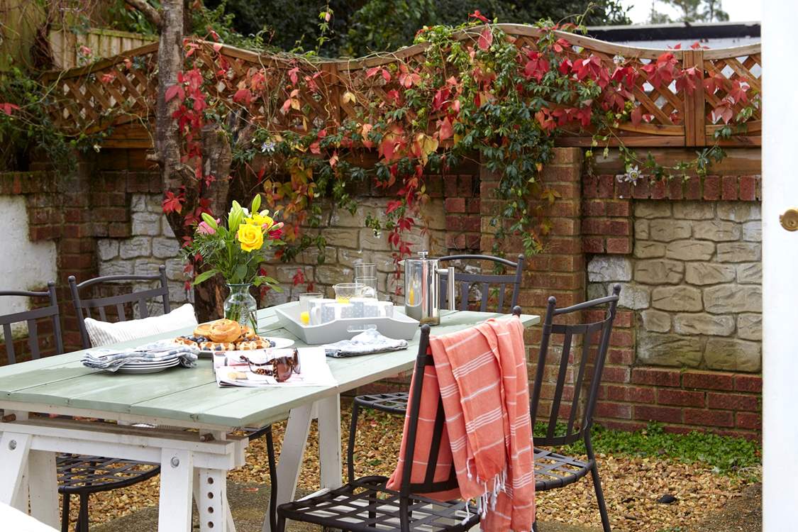 The rear courtyard is the perfect spot to enjoy a cup of coffee and a good read.